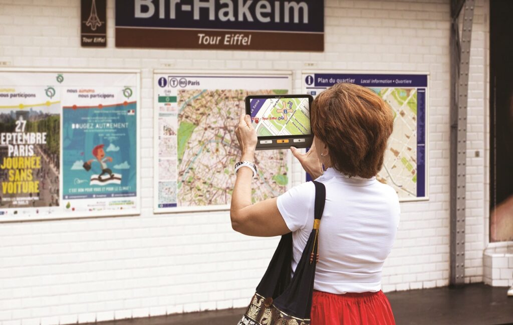 Woman Using Explore 8 Video Magnifier to View Map